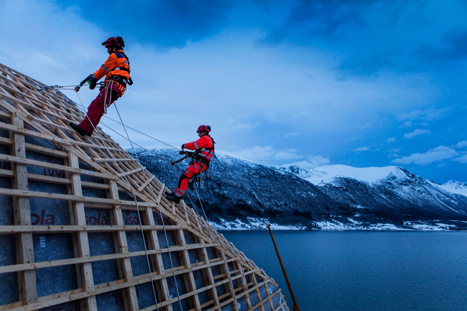 Workers in safety harnesses on a construction site in Northern Norway